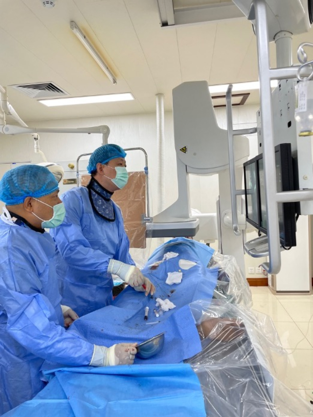 李凱教授（右）和劉海濤教授（左）為患者行TACE手術(shù)。中國駐老撾大使館供圖