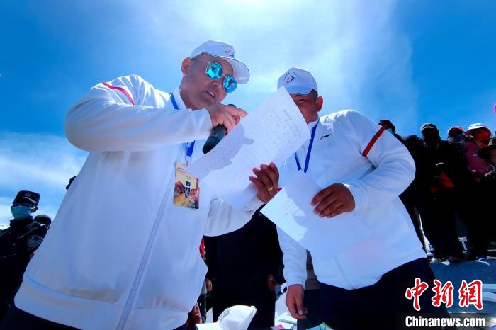 圖為裁判員統(tǒng)計牧民運動項目比賽成績?！±铍h 攝