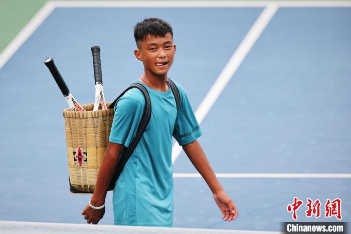 王發(fā)背著背簍在賽場上?！±罱ㄋ?攝