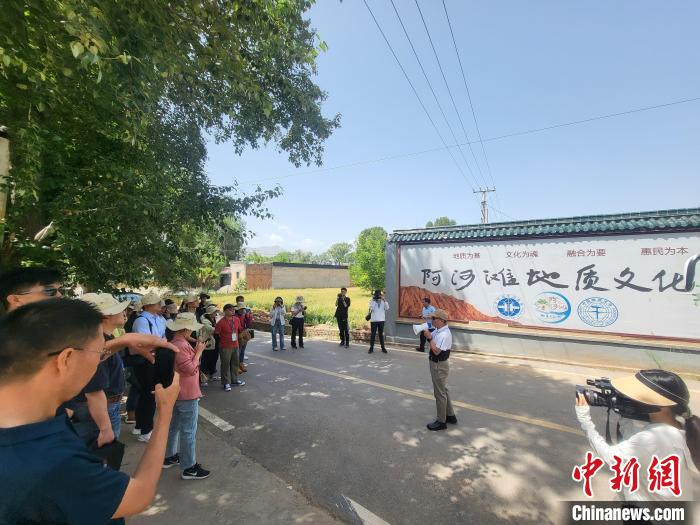 圖為中國(guó)地質(zhì)大學(xué)(北京)教授張緒教介紹村落情況。　胡友軍 攝