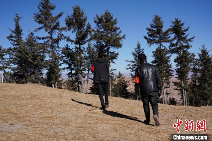 圖為桑杰加(左)和同事巡查林場?！●R銘言 攝