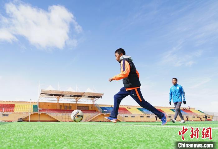 圖為一名男孩運(yùn)球射門?！●R銘言 攝