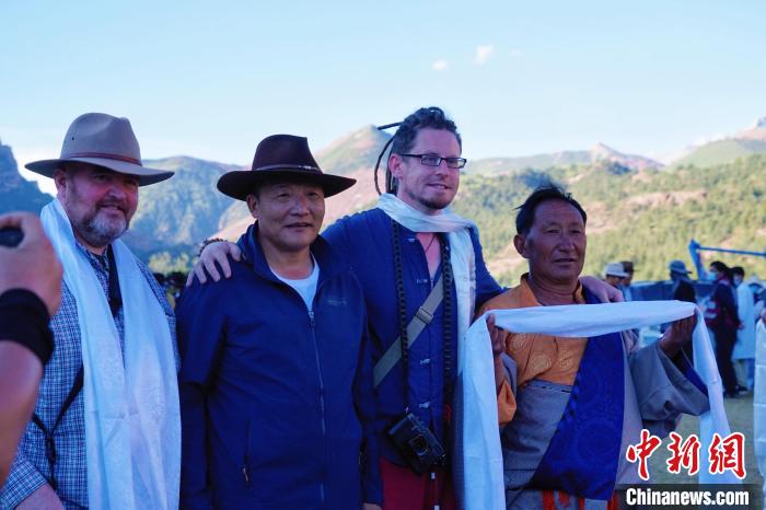 圖為當(dāng)?shù)孛癖娕c外籍?dāng)z影師合影留念?！●R銘言 攝