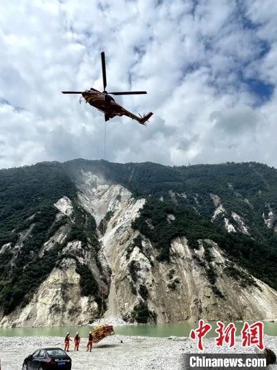 直升機(jī)正在運(yùn)輸110千伏唐下線應(yīng)急塔塔材。　衛(wèi)科 攝